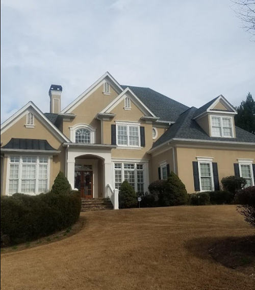 Elegant residential home with a newly installed roof, featuring high-quality shingles and expert craftsmanship for long-lasting protection